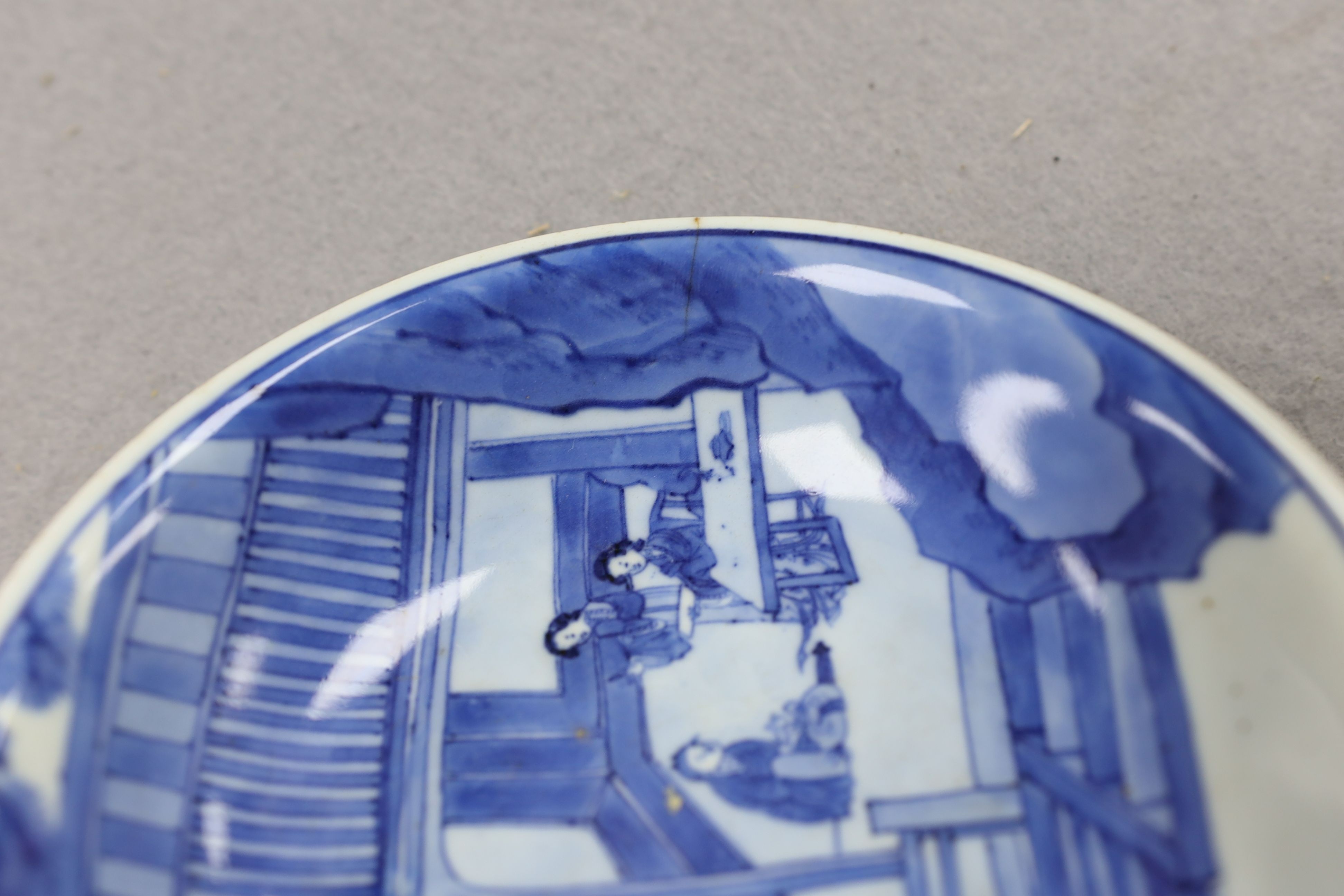 NB BOTH WITH HAIRLINE CRACKS A pair of Chinese blue and white small dishes, Kangxi six character marks and of the period (1662-1722), 15.7cm and 15.8cm diameter, foot later pierced, hairline cracks